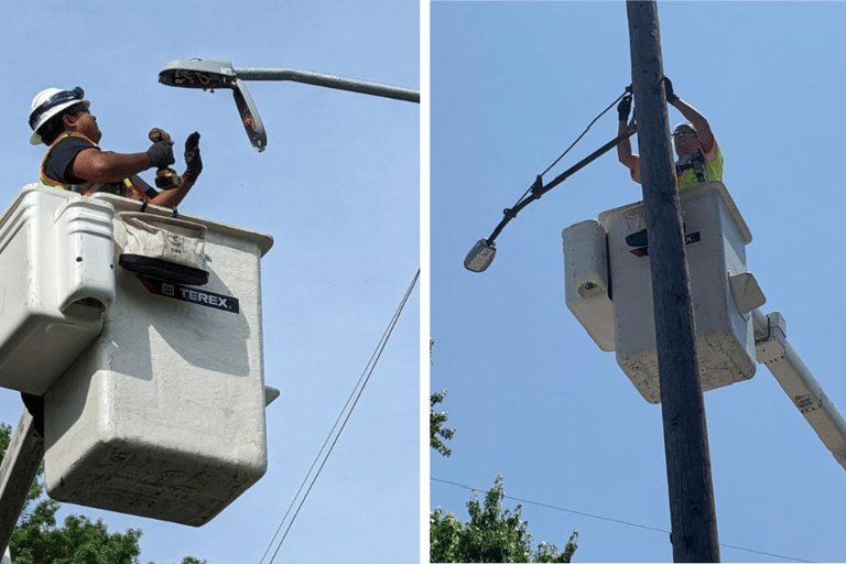 Crew in bucket trucks installing street lighting